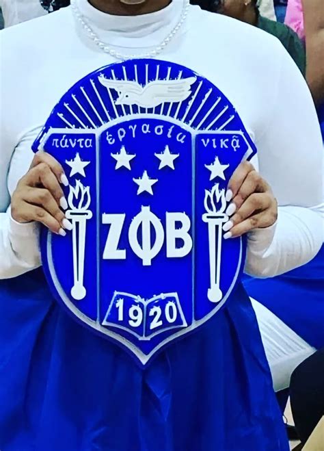 What does the greek inscriptions on the zeta phi beta shield.